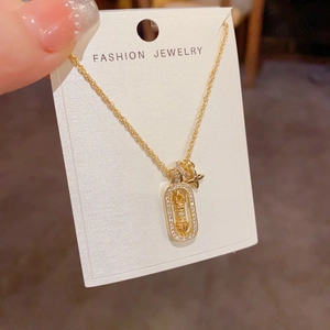Elegant gold square star necklace with pavé cubic zirconia on a white card