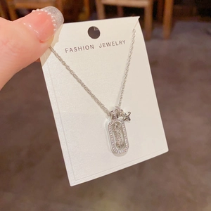 Detail of a rotating star pendant necklace with cubic zirconia on a fashion display card