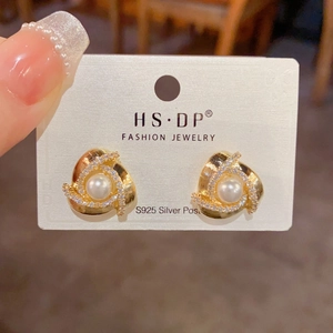 Elegant gold spiral stud earrings with white pearl and micro-pave cubic zirconia accents