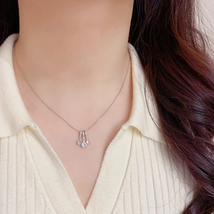 Elegant silver-tone geometric triple pendant necklace with cubic zirconia on a model