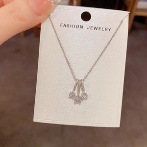 Macro detail of geometric silver pendant necklace with sparkling zircons and fine chain