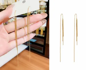 Detail of long gold chain tassel earrings featuring S925 silver needles for sensitive ears