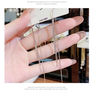 Detail showing S925 silver needles on long chain tassel earrings with silver finish