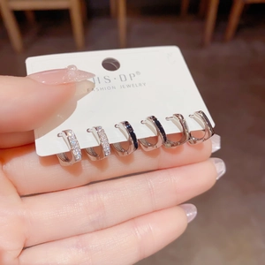 Detail van een 6-delige zilveren huggie-oorbellen set met zwart emaille en zirkonia's