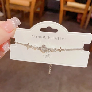 Detailed shot of silver flower bracelet with sparkling zircons and delicate white pearls