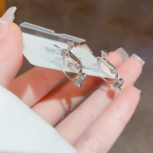 Minimalist silver screw-on ear clips with silicone pads for non-pierced ears