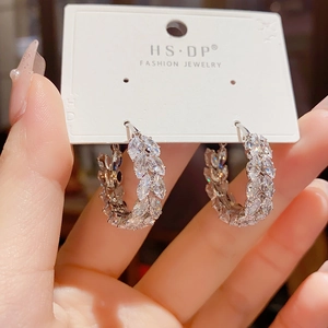 Chic silver hoop earrings with marquise-cut zircons displayed on a branded card
