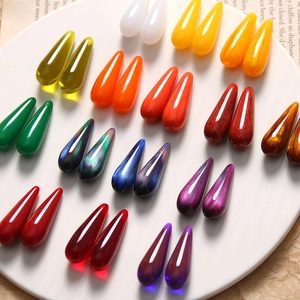 Macro shot of assorted colorful teardrop resin charms for DIY jewelry and earrings