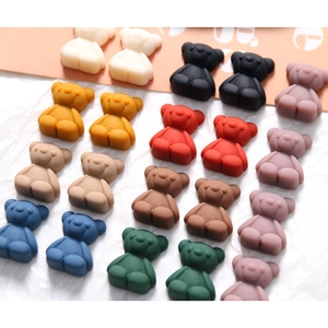 Detailed overhead view of colorful matte resin bears for DIY jewelry and crafts