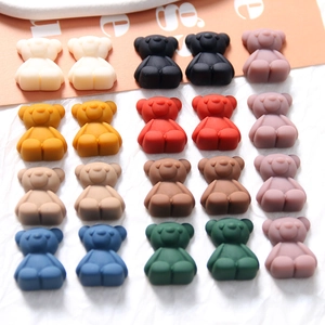 Flat lay of colorful matte resin bears for DIY crafts and jewelry making