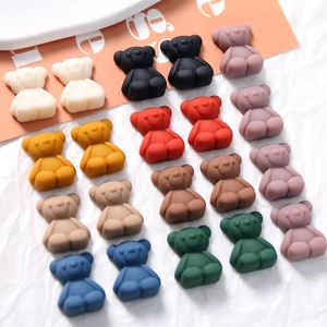 Macro view of multi-colored matte resin bear charms with smooth frosted finish for DIY