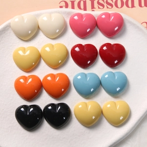 Macro view of assorted glossy resin heart charms in vibrant colors for DIY jewelry crafts