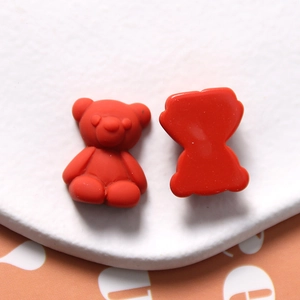 Detail of red matte resin bear charms showing 3D front and flat back for DIY crafts