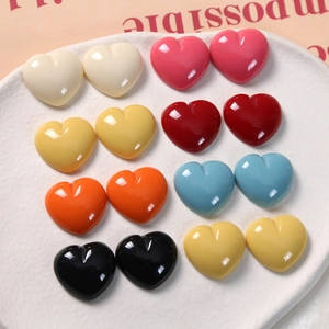 Detailed view of colorful glossy heart resin charms for DIY jewelry and hair accessories