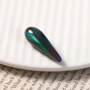 Macro shot of green liquid-sand texture resin waterdrop pendant for DIY craft jewelry