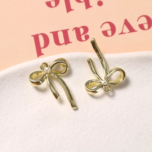 Detail van vintage gouden strikbedeltjes met witte parel voor het maken van sieraden