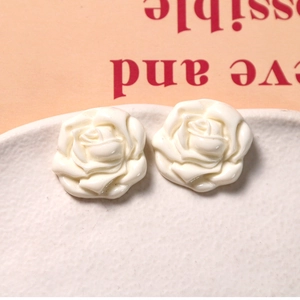 Macro shot of white resin rose flower charms for DIY jewelry and accessories