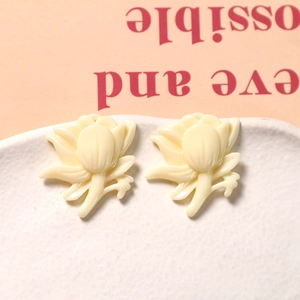 Close-up of cream resin daisy charms for DIY earrings and hair accessory decorations