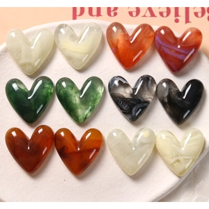 Vue détaillée des cabochons en résine en forme de cœur avec texture marbrée à l'encre