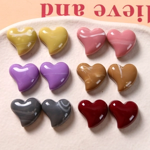 Detail of heart-shaped DIY resin accessories with marble texture in six assorted colors
