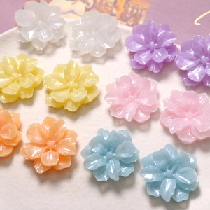 Macro shot of colorful resin gardenia flower charms for DIY jewelry and accessories