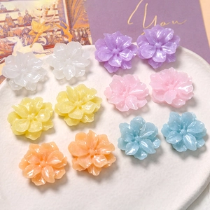 Macro detail of glitter resin gardenia flower patches in assorted vibrant pastel colors