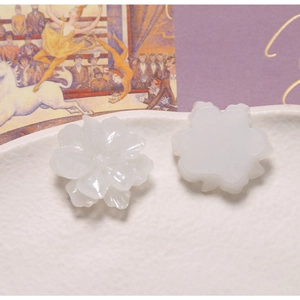 Detail showing translucent resin gardenia flower charms with textured petals and flat back