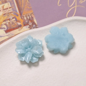 Close-up of light blue resin flower petals with glitter powder for DIY accessories