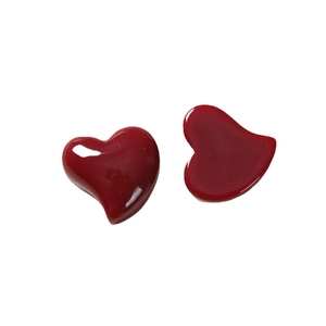 Minimalist red heart resin earrings with a polished glossy finish on a white background