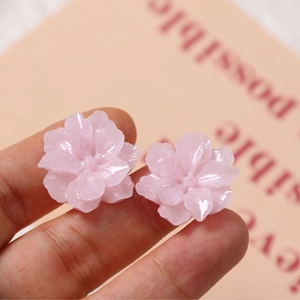 Close-up of pink gardenia flower resin charms for DIY jewelry and hair accessories