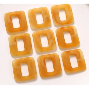 Nine amber marble resin square frame pendants for DIY earrings in 3x3 grid display