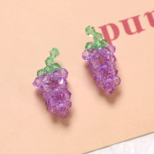 Detail of handmade purple acrylic grape charms with faceted beads for DIY jewelry