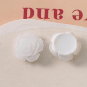 Close-up of white 19mm resin rose charm showing 3D petals and flatback base for DIY craft