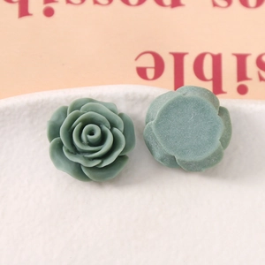 Macro view of sage green rose flower resin cabochons for DIY jewelry and hair accessories