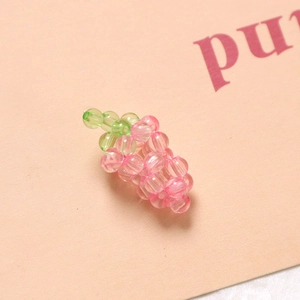 Detail of pink and green acrylic grape bead pendant for DIY crafts and jewelry making