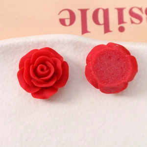 Macro view of 20mm red resin rose charms showing 3D front petals and flat back base