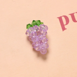 Macro view of handmade 3D crystal grape pendant with faceted lavender beads and green leaf