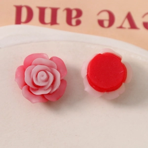 Macro detail of 19mm red pink gradient resin rose flower charms for DIY crafts