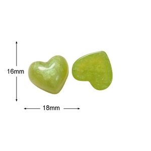 Macro detail of green glitter resin heart charms with 18mm by 16mm size measurements
