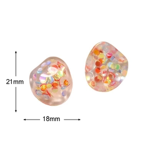 Close-up of pink translucent resin pebbles with iridescent sequins measuring 21mm by 18mm