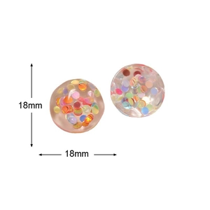 Detail showing 18mm round clear resin charm with colorful sequins for DIY jewelry