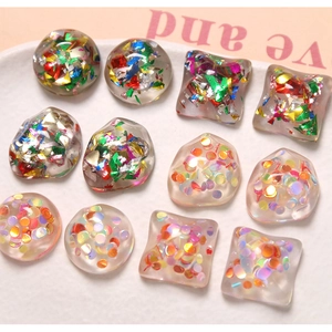 Detailed macro view of colorful translucent glitter resin gems with gold foil flakes