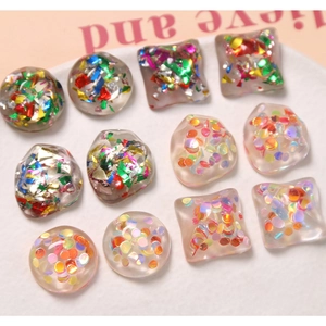 Detailed view of translucent resin charms with colorful glitter and sequins for DIY crafts