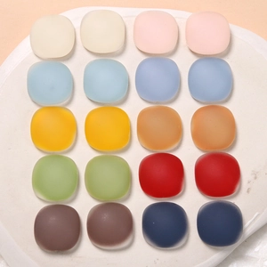 Close-up of matte resin square charms in twenty vibrant colors for jewelry making