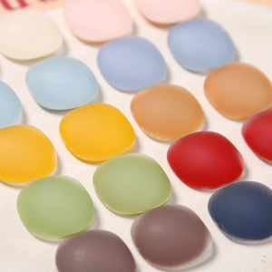 Close-up of matte resin square tiles in colorful Morandi tones for DIY jewelry making