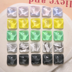 Macro shot of 25 colorful water-ripple resin squares for DIY jewelry making