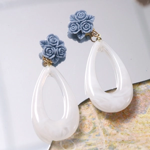 Ink marble teardrop earrings with blue resin rose detail and geometric cutout design