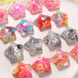 Detailed macro of transparent star resin beads with colorful clay confetti for DIY crafts