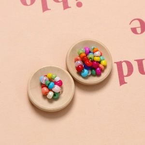 Mixed color concave round wooden buttons in a small decorative bowl for DIY sewing