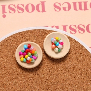Close-up of colorful wooden bowl buttons for DIY clothing accessories in wooden trays